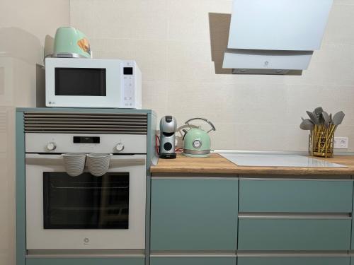 a kitchen with a microwave on top of a oven at Castaños 4 in Alicante