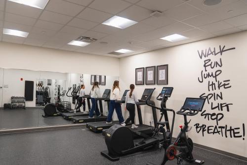 a group of people exercising in a gym at The Bradley in Fort Wayne