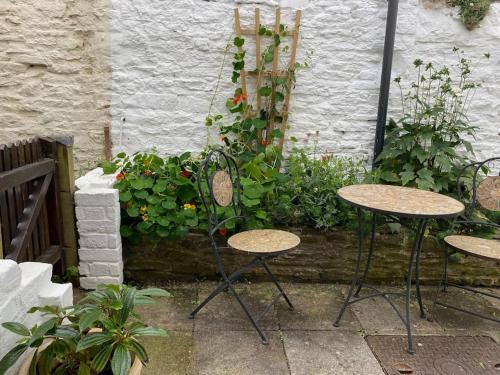 a group of tables and chairs in a garden at Lavender Cottage, 3 School Road, Clun, Shropshire in Clun