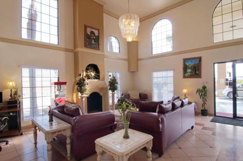 a living room with couches and a fireplace at Texas Inn & Suites Pharr/San Juan in Pharr