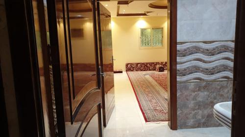 a bathroom with a glass door leading to a hallway at شقق لافندر in Sūq ath Thalut