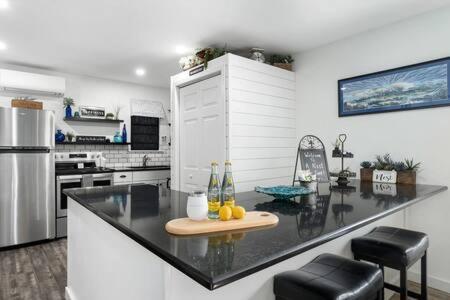 a kitchen with a counter with bottles on it at A Nest For Two, Bathhouse, Firepit, Sleeps 2 in Fredericksburg