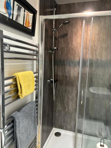 a shower in a bathroom with a glass shower stall at Firbank House in Glenrothes