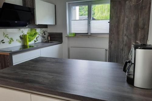 a kitchen with a wooden counter top in a kitchen at Ferienhaus-Ferienwohnung Weitblick mit Garten und malerischem Bergpanorama in Oberammergau