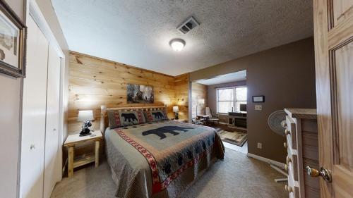 a bedroom with a bed and a wooden wall at Heaven's Door in Pigeon Forge