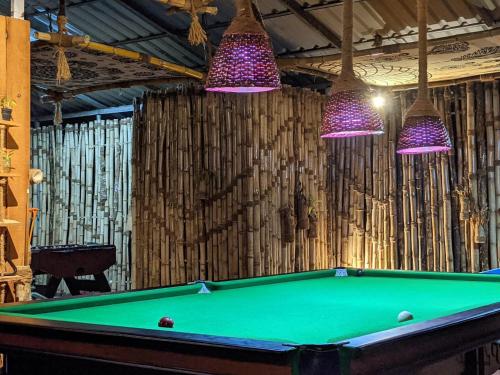 a pool table with purple lights above it at Casa Branca Retreat in Varkala