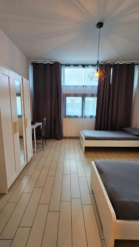 a bedroom with a bed and a table and a window at AK Homes, a due passi da Orio in Azzano San Paolo