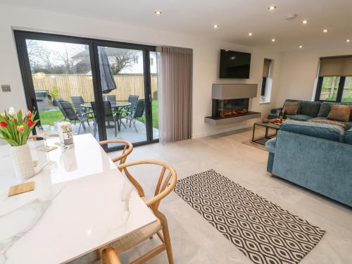 a living room with a table and chairs and a couch at Tredarn in Hayle