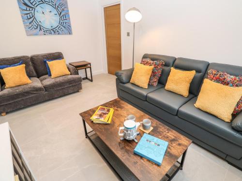 a living room with a couch and a coffee table at Tredarn in Hayle