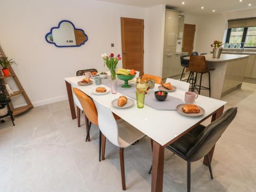 a dining room with a white table and chairs at Tredarn in Hayle