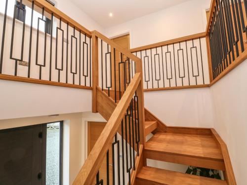 a staircase in a house with wooden railings at Tredarn in Hayle