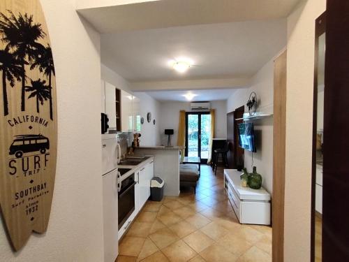 a kitchen and living room with a sink and a stove at Apartments Zezelj in Sveti Stefan