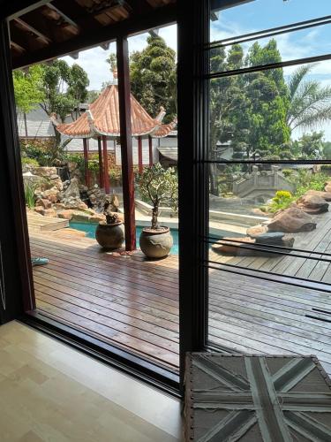 a view of a deck through a glass door at Oasis On Lily with OWN Pool in Johannesburg