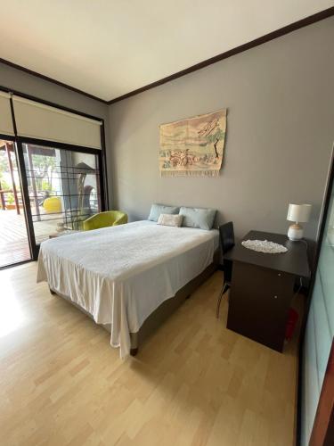 a bedroom with a large bed and a table at Oasis On Lily with OWN Pool in Johannesburg