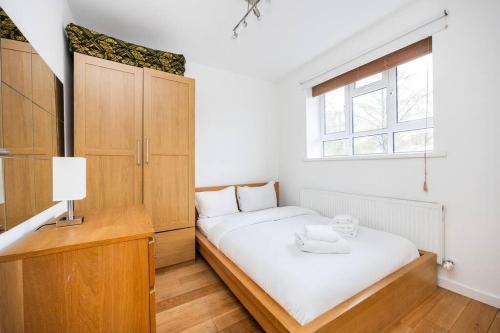 a bedroom with a white bed and a window at Comfortable 2 Bedroom in Marylebone in London