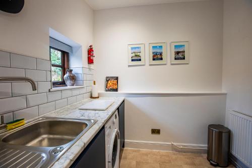 a kitchen with a sink and a counter at The Carriage House a relaxing 1-Bed Cottage in Ash in Ash