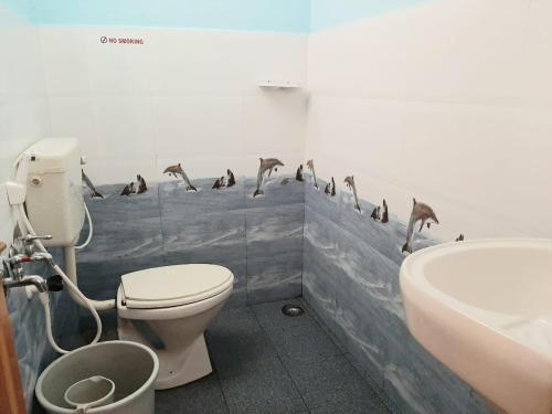a bathroom with a flock of birds on the wall at Sunrise Villa Coorg in Madikeri