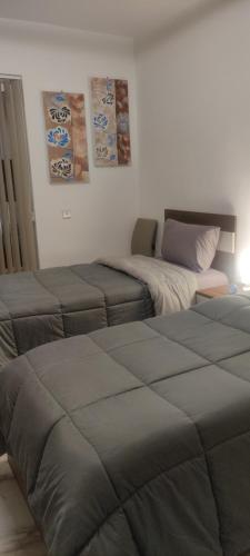 a room with two beds and a bed at Relax in Victoria
