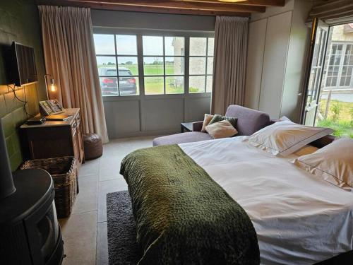 מיטה או מיטות בחדר ב-Te Lande, vakantiehuis
