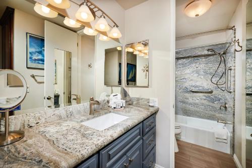 baño con lavabo y espejo grande en D205 - Serenity Hideaway en Oceanside