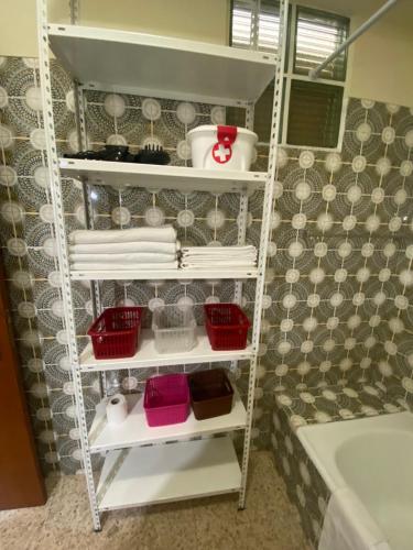 a towel rack in a bathroom with towels and a tub at Casa Encantada - Benfica in Lisbon