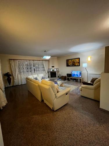 uma sala de estar com dois sofás e uma televisão em Casa do Eirô em Resende