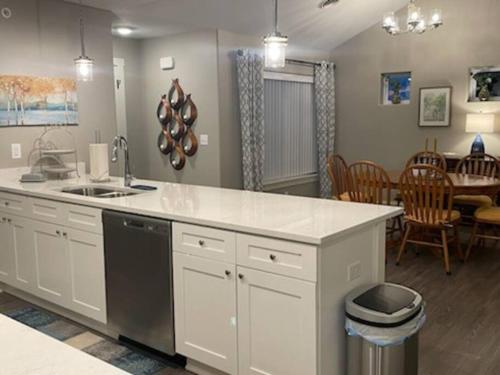 a kitchen with a counter and a dining room at Brand New 3 Bedroom Condo in Bettendorf in Bettendorf