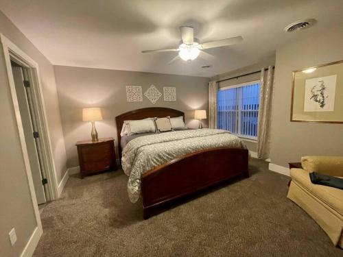 a bedroom with a bed and a ceiling fan at Brand New 3 Bedroom Condo in Bettendorf in Bettendorf