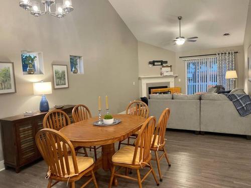 a living room with a wooden table and chairs at Brand New 3 Bedroom Condo in Bettendorf in Bettendorf