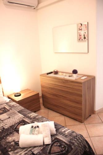 a bedroom with a bed and a wooden cabinet at Anzio- central holiday house - Daniele Case Vacanza in Anzio
