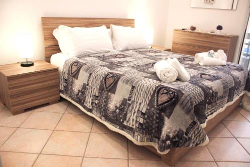 a bedroom with a bed with a black and white blanket at Anzio- central holiday house - Daniele Case Vacanza in Anzio