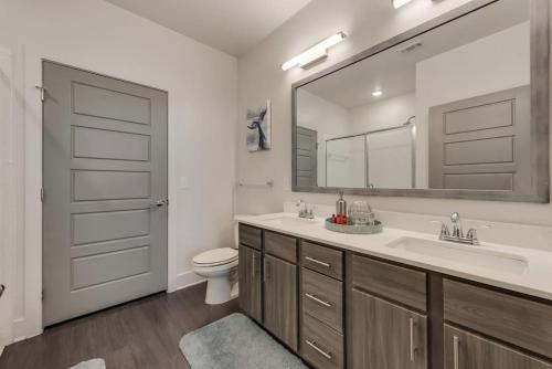 艾伦ALL041 -Luxe 2BD 2BA Apt in Allen的带水槽、马桶和镜子的浴室