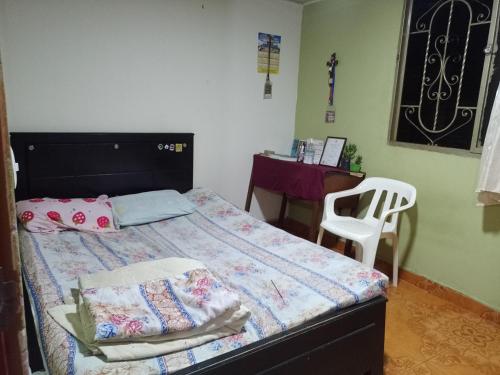 1 dormitorio con cama, escritorio y silla en Alojamiento Don Luis, en Popayán