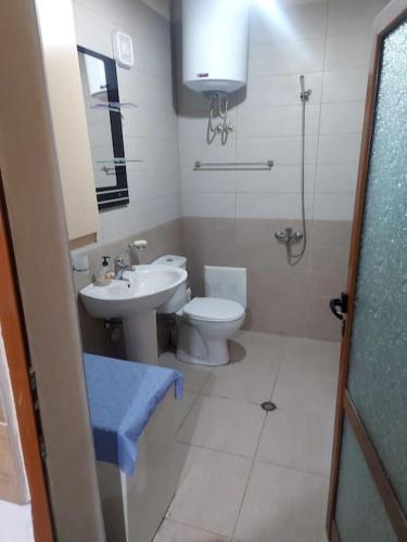 a bathroom with a toilet and a sink and a shower at Vila Ceku in Dardhë
