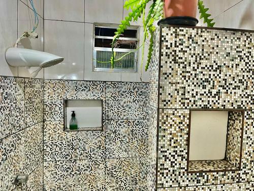 a tiled bathroom with two windows and a shower at Carnaval de Salvador no coração da Sereia - Ondina in Salvador
