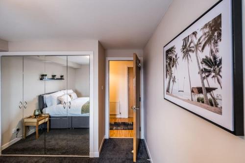 a bedroom with a bed and a glass doorway at Union Square modern 2 bedroom apartment in Aberdeen