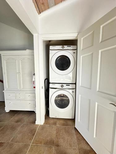 a washer and dryer in a room with a door at A'Viva Grace Bay - Alta3 in The Bight Settlements