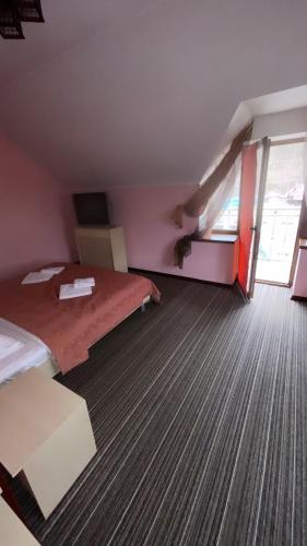 a room with a bed and a staircase in it at Moonglade Allure Houses in Polyana