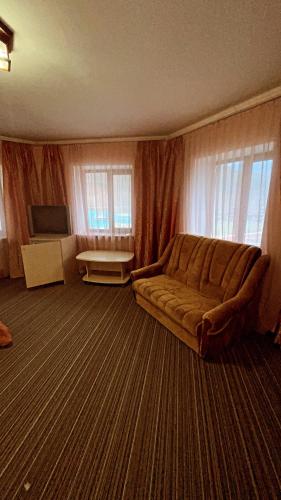 a living room with a couch and a table at Moonglade Allure Houses in Polyana