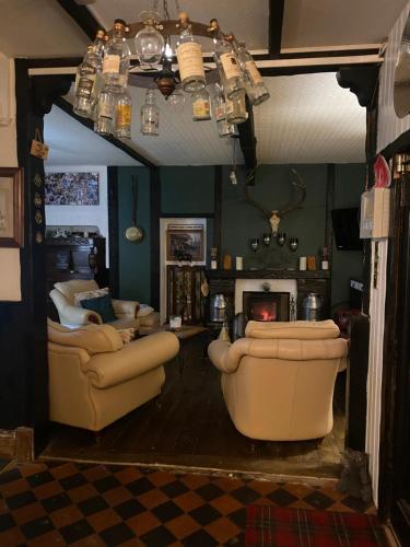 a living room with two couches and a fireplace at Craighlaw Arms Boutique B&B in Kirkcowan