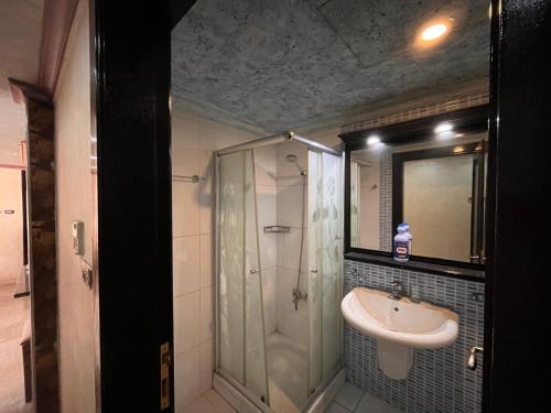 een badkamer met een douche en een wastafel bij Tarawneh & Thawabi in Amman