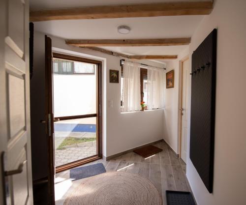a hallway with a large window and a door at Ház a szígeten in Fonyód
