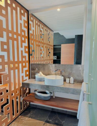 a bathroom with a sink and a large mirror at Luxury Studio-private individual pool-IIK C409 By Sandy Powerful in Tulum