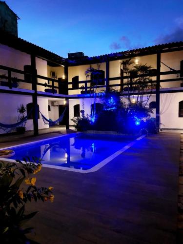 a house with a swimming pool at night at Pousada Solar de Itaúna in Saquarema
