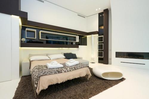 a bedroom with a bed with two towels on it at [Duomo-City Life] Luxury Design Loft in Milan
