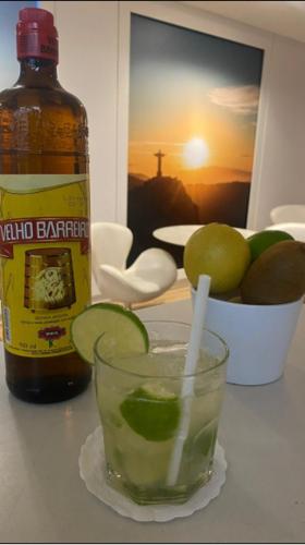 a bottle of alcohol and a drink on a table at Samba Bossa Nova Ipanema in Rio de Janeiro
