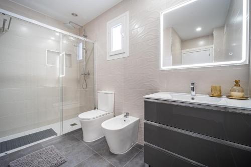 a bathroom with a toilet and a sink and a shower at Brand New apartment in Benalmádena