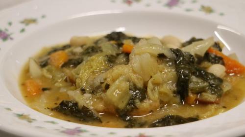 a white bowl of soup with vegetables in it at Agriturismo La Sovana in Sarteano