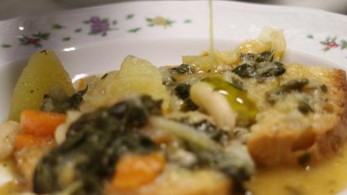 a plate of food with vegetables on a table at Agriturismo La Sovana in Sarteano