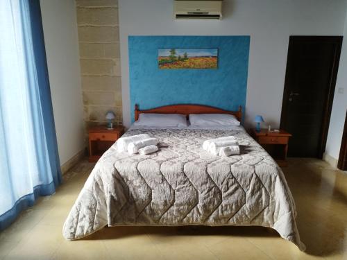 a bedroom with a bed with two towels on it at B&B Terra Serena in Santa Cesarea Terme